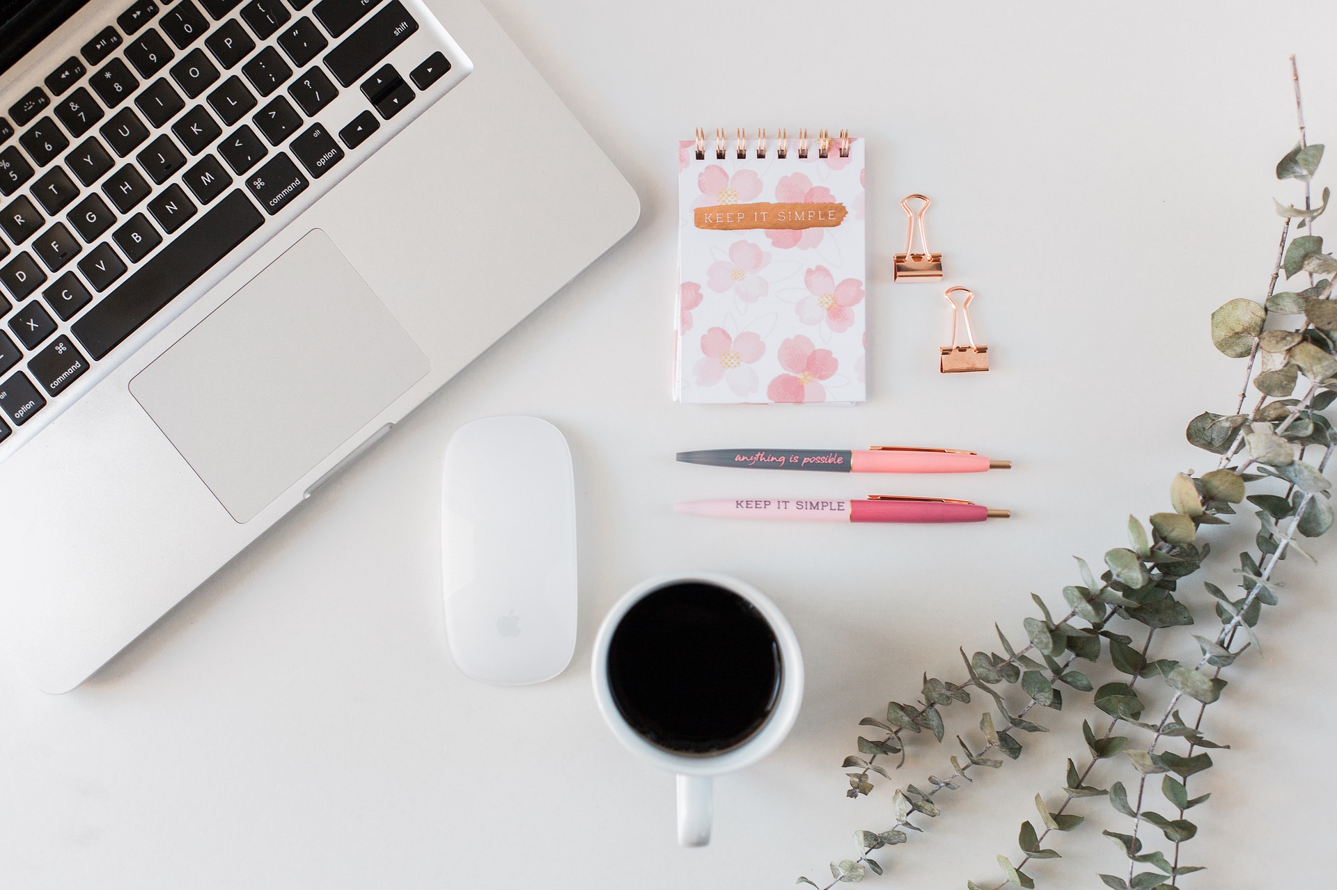 flat lay of a desk with laptop, notepad, pens, mouse, and coffee as blog main image for confessions of an organized homemaker book review